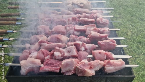 Delicious pork skewers grilling over coals for a barbecue