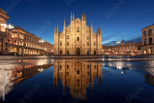 Illuminated Duomo di Milano and Galleria Vittorio Emanuele II with water reflection in Piazza del Duomo, Milan