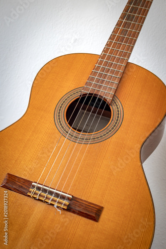 Close up of classical Spanish guitar with wooden body and strings