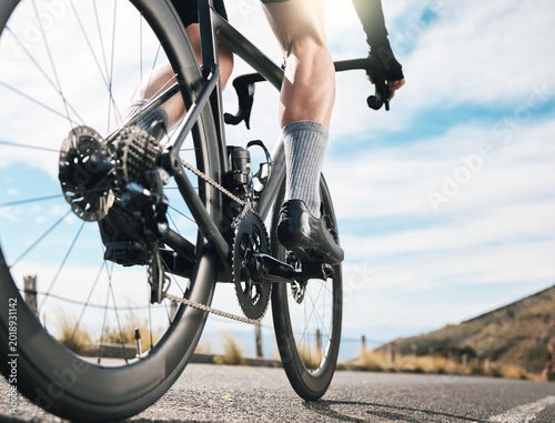 Foto Exercise, legs and person on road with bike, endurance training or challenge in cardio workout