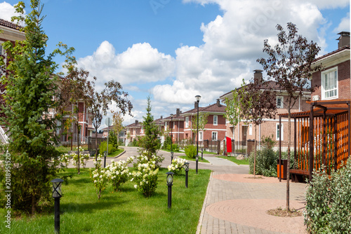 Modern suburban townhouse community with brick facades and pedestrian walkway