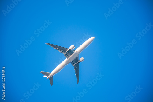 A passenger plane in the clear blue sky.