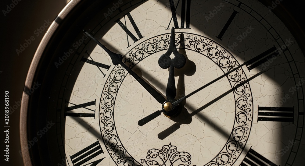 Fototapeta premium Close-up of antique clock face nearing deadline with dramatic midday shadows, symbolizing time pressure and urgency