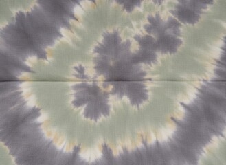 Tie dye fabric background with abstract spiral patterns for fashion lookbooks, textile industry presentations and creative garment design mockups