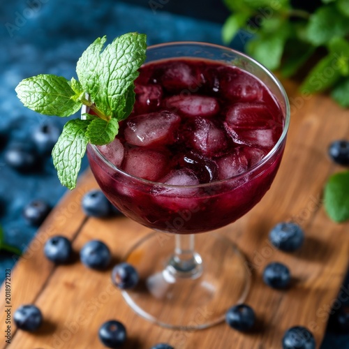 Fresh Blueberry Mint Drink Served in a Clear Glass on a Wooden Board With Ber...