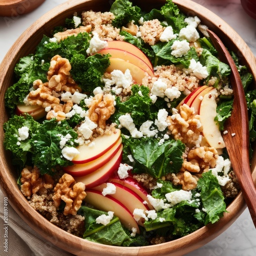Healthy Salad With Quinoa, Kale, Apples, Walnuts, and Cheese in a Wooden Bowl...