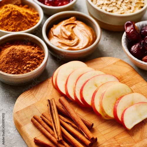 Sliced Apples With Peanut Butter and Spices on Wooden Cutting Board in Kitche...