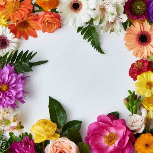 Bright Flowers Arranged on a White Surface Creating a Colorful Background for...