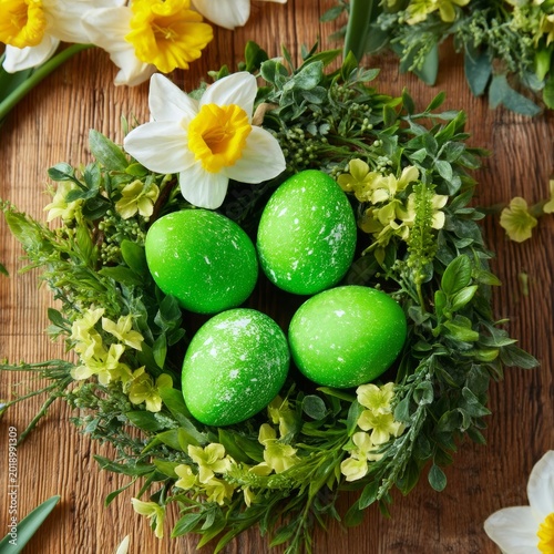 Green Eggs in a Nest Surrounded by Flowers on a Wooden Surface During Spring ...