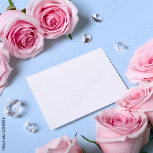 Three Pink Roses With a Blank Card on a Blue Background for a Simple Message