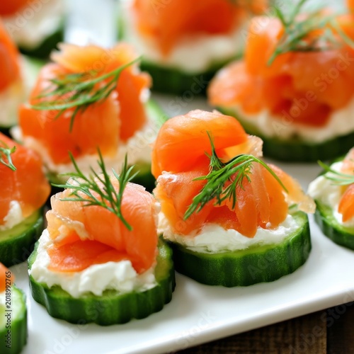 Cucumber Slices Topped With Cream Cheese and Smoked Salmon Served on a White ...