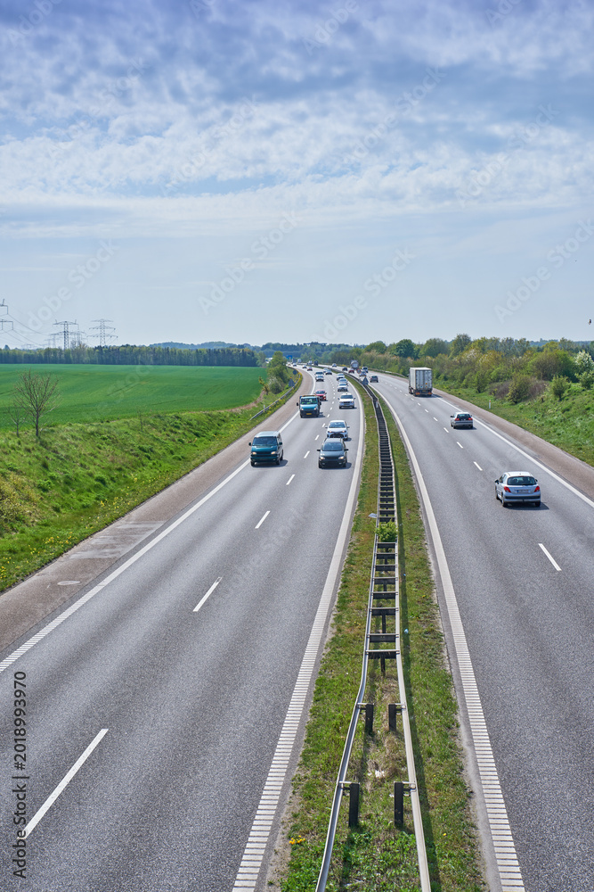Naklejka premium Cars, highway and landscape with scenic view of nature in summer for commute, drive or travel. Background, sky and tourism with vehicles on asphalt road for countryside or rural transportation