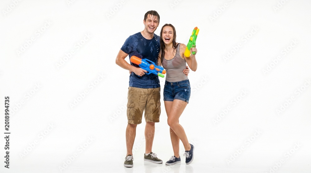 Fototapeta premium Young couple playing with water guns.