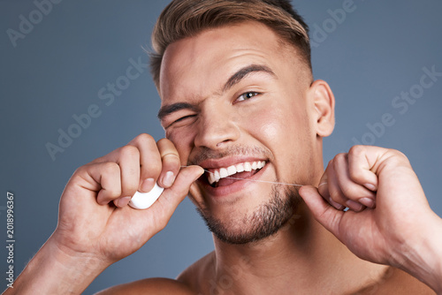 Schilderij op canvas Dental, portrait or man in studio with floss, mouth health or cavity prevention in orthodontics