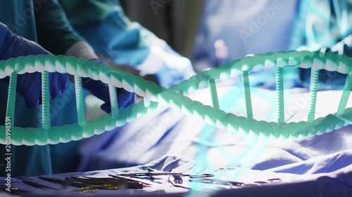 Surgical hands reaching tray lining forceps on drape prepping while DNA helix drifting over hands