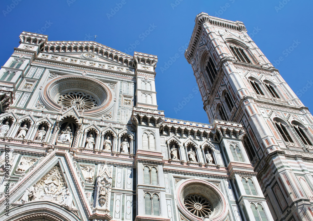Fototapeta premium Front Facade and Giotto's Bell Tower of Florence Cathedral in Italy clear blue sky