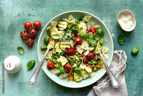 Traditional italian pasta primavera with spring vegetables. Top view with copy space.