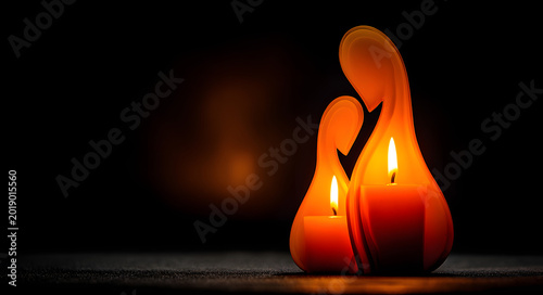 A candle that is shaped like a mother embracing her child and emits a warm glow on a dark background, representing remembrance and love.