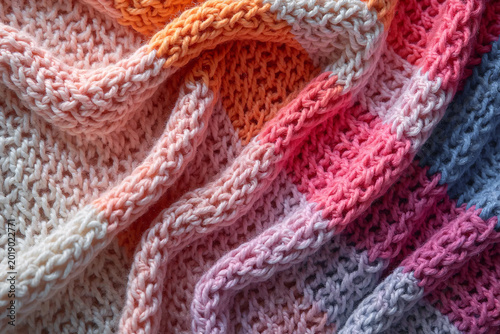 Crinkled knitted fabric made of pure wool with colored stripes. Top view.