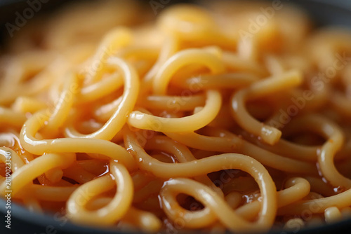 Long pasta in tomato sauce. Close-up.