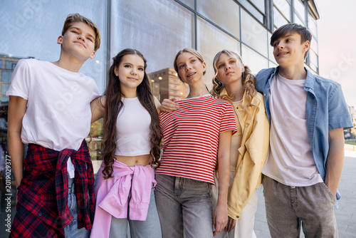 Group of diverse teenagers posing together in urban setting