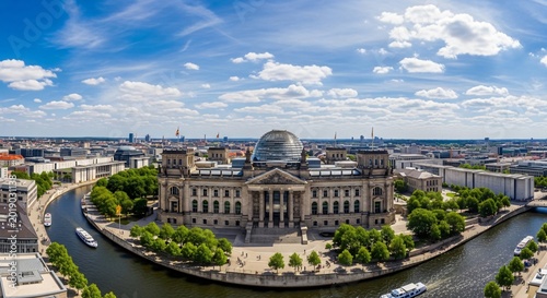 Reichstag building in Berlin with iconic glass dome and Spree river, German parliament landmark, historic architecture, government center, memorial and democracy symbol, sunny day.
