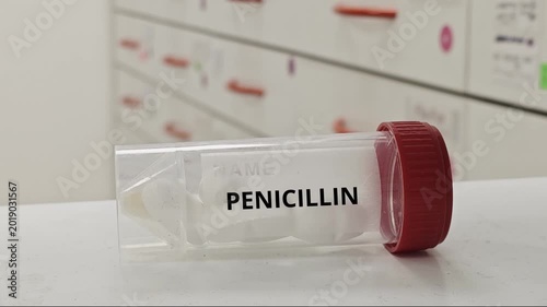 PENICILLIN tablets used to treat bacterial infections by inhibiting cell wall synthesis in a plastic box