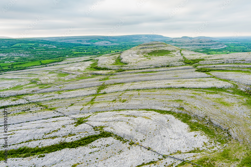 Naklejka premium Aerial view of Burren National Park in County Clare, Ireland. Dramatic limestone karst landscape on the Wild Atlantic Way with green fields and wild countryside.