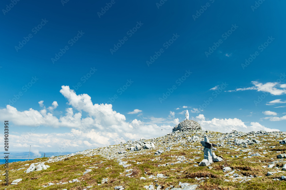 Naklejka premium Statue of the Virgin Mary on Minaun Heights, Achill Island, County Mayo, Ireland. Rocky mountain summit with sweeping Atlantic views on the Wild Atlantic Way.