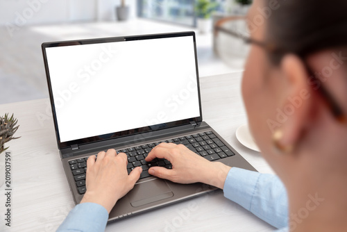 Female professional working on laptop with isolated display in contemporary office, designed for branding, SaaS, online learning or marketing mockup usage