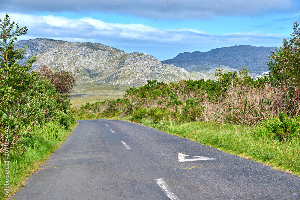 Naklejka premium Landscape, nature and street on mountain for travel, tourist destination and journey in valley. Empty, background and outdoor with motorway for road trip, scenic route and distance in countryside