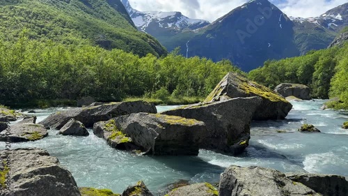 The river flows through huge rocks among the mountains
