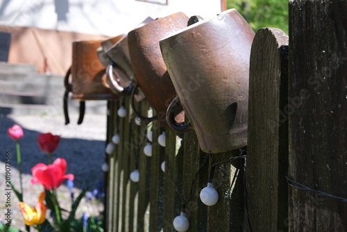 Konstfotografi Clay pots hang on a wooden fence.