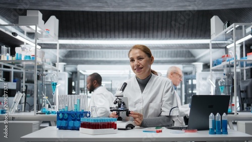 Canvas Print Clinical microbiologist using compound microscope for detailed cellular analysis research