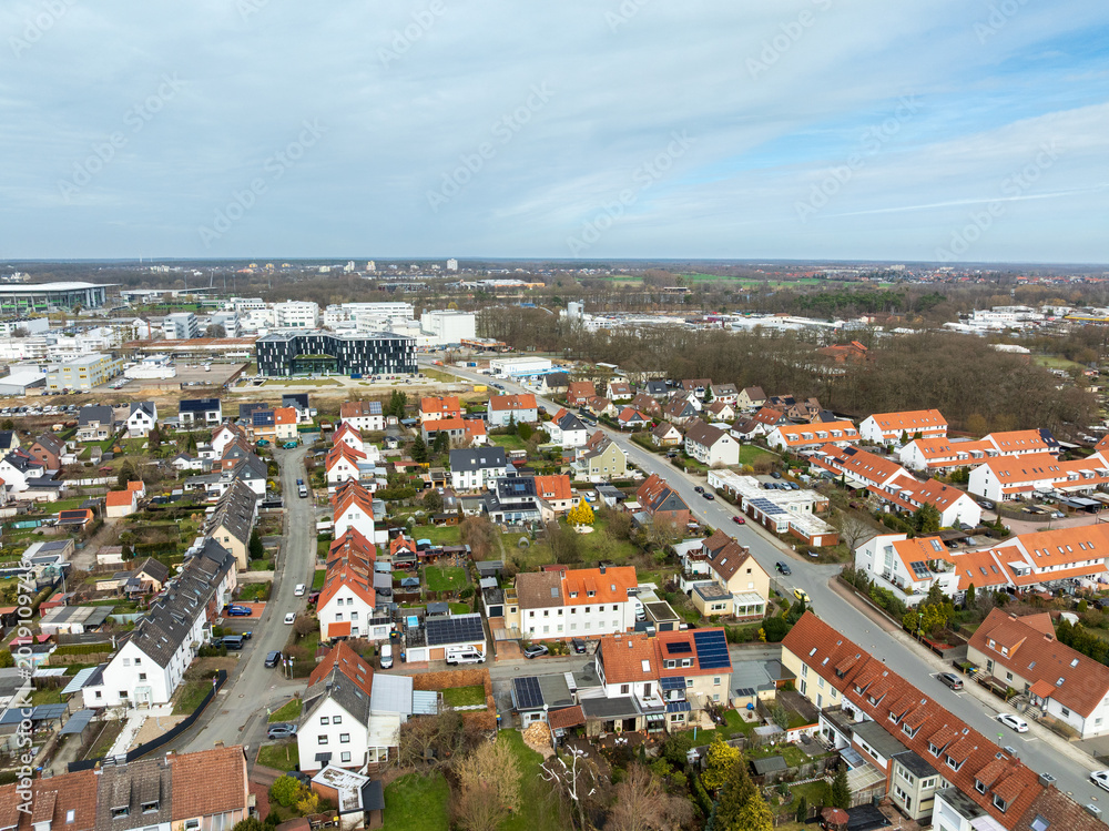 Fototapeta premium Aerial view of Stadtmitte district in Wolfsburg with residential area and industrial skyline