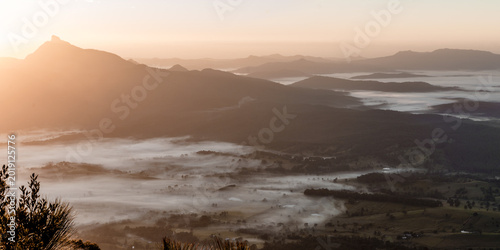Golden sunrise over sea of fog in mountain valley, Australia