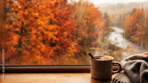 Foto Steaming mug of coffee beside window with autumn foliage view
