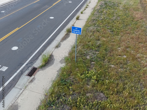 Blue sign marking the start of an electric vehicle charging lane.