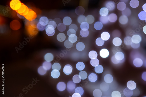 A mesmerizing bokeh effect with golden and multicolored lights on a dark background, ideal for holiday or dreamy compositions with a glow.