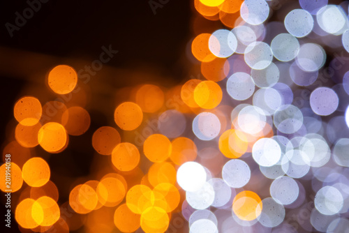 Vibrant golden and multicolored light bokeh on a dark canvas, perfect for festive, artistic, or romantic themes with a dreamy effect.