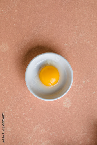 egg yolk removed from the shell and placed in a white bowl