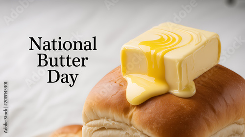 A stick of butter melting on a loaf of bread with 'National Butter Day' text