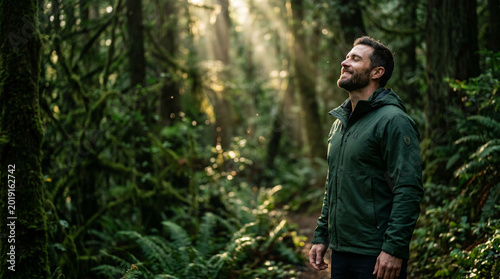 Man taking a deep breath of fresh morning air in peaceful forest perfect for wellness relaxation and freedom concepts