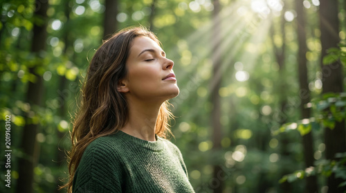 Woman breathing fresh morning air in peaceful forest perfect for mental health wellness relaxation and freedom concepts