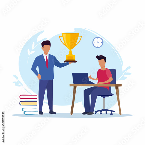Mentor presenting trophy to student working on laptop