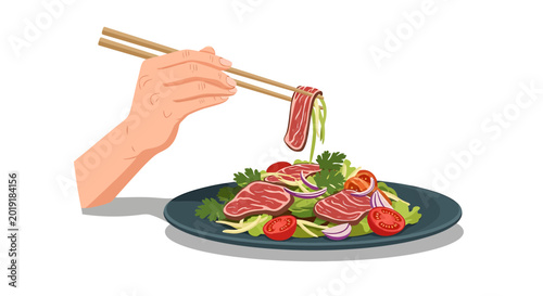 Fresh beef salad with vegetables being eaten with chopsticks