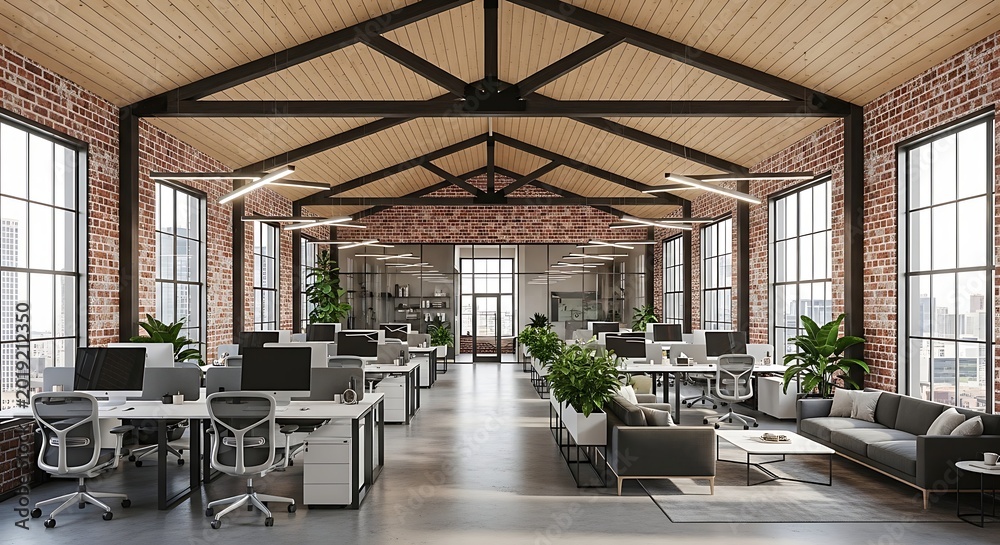 Fototapeta premium Large open plan office space with brick walls and high ceilings featuring workstations and seating areas