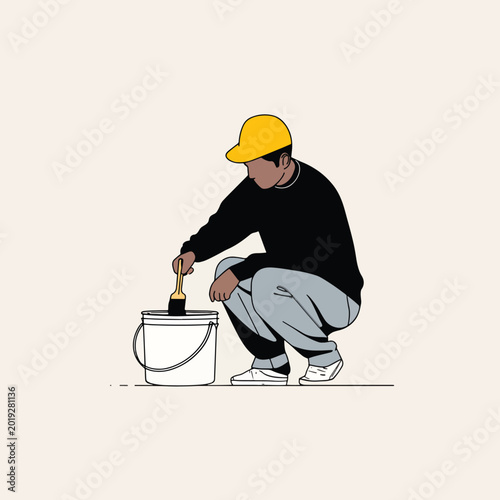 Man crouching with paint bucket.