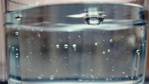 Refreshing Carbonated Water Bubbles Rising in Glass Close Up