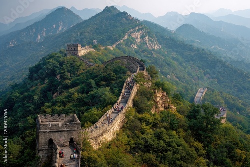 Great Wall of China winding through lush green mountains